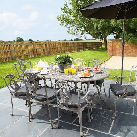 Serve croissants, pastries, fruit and coffee for an alfresco breakfast
