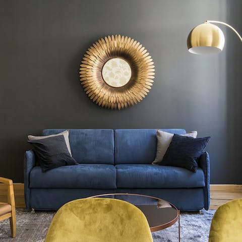 Sink into the inviting blue velvet sofa after a day of exploring Rome's historic centre