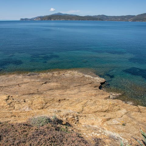 Walk down the path to the private beach for a dip in the sea