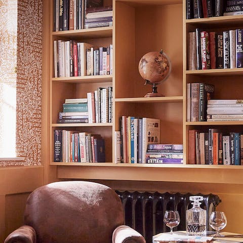 Hunker down in the library with a nightcap in hand and peruse the shelves