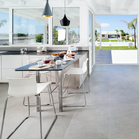 Enjoy a light breakfast in the light-filled, glass-paned kitchen