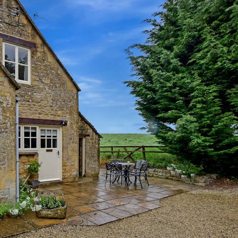 Sit outside on the home's patio with dinner smoking away on the barbecue