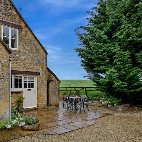 Sit outside on the home's patio with dinner smoking away on the barbecue