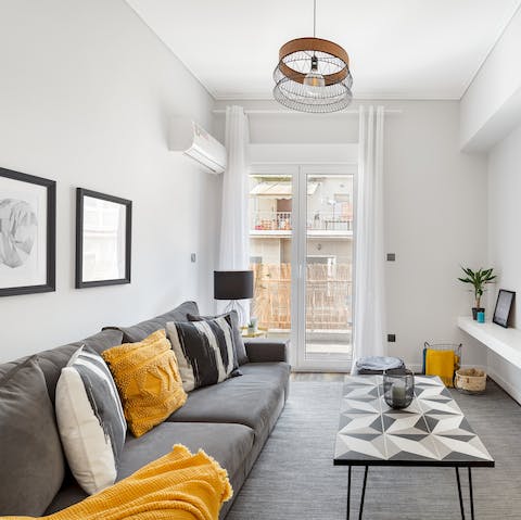 Kick back in the stylish living room with a glass of wine after a day of exploring the city