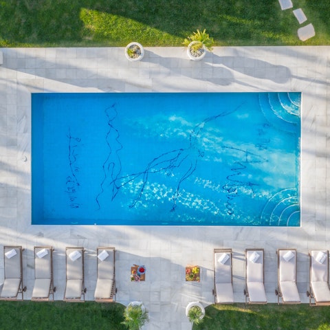 Swim in the private pool featuring an iconic sketch by Picasso