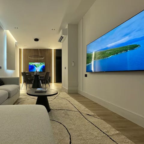 Watch a film from the couch or dining area