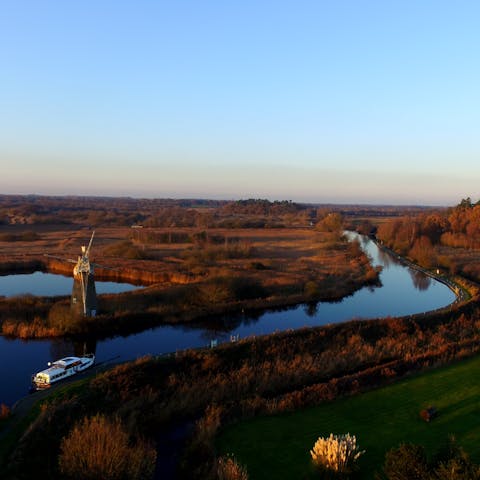 Take a boat along the Norfolk Broads to explore the wetlands abundant wildlife