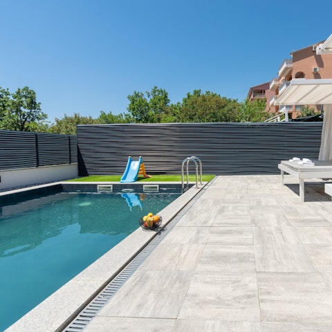 Relax in the Croatian sunshine on a daybed next to the private pool