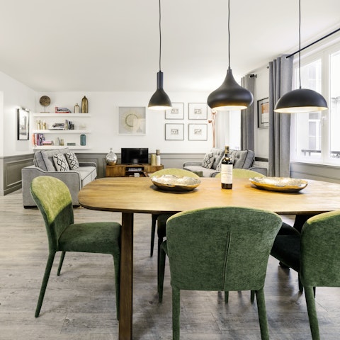 Gather round the stylish dining table for cheese, fresh bread, and a glass of wine