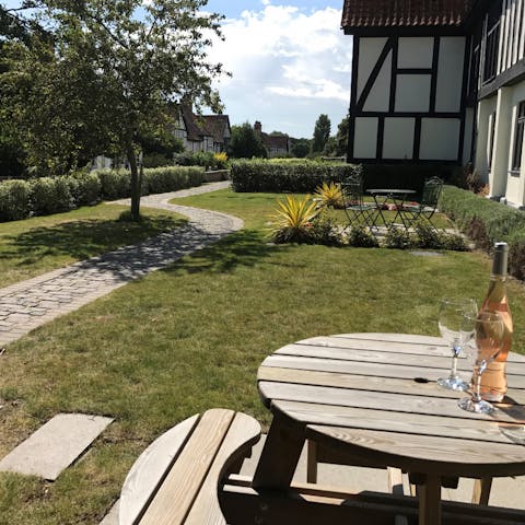 Dine alfresco in the shared, landscaped garden after a walk on Thorpeness Beach