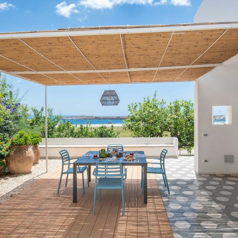 Have a glass of Sicilian wine in the dappled shade