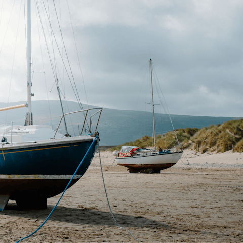Enjoy a brisk stroll along Barmouth Beach, a twenty-minute drive away