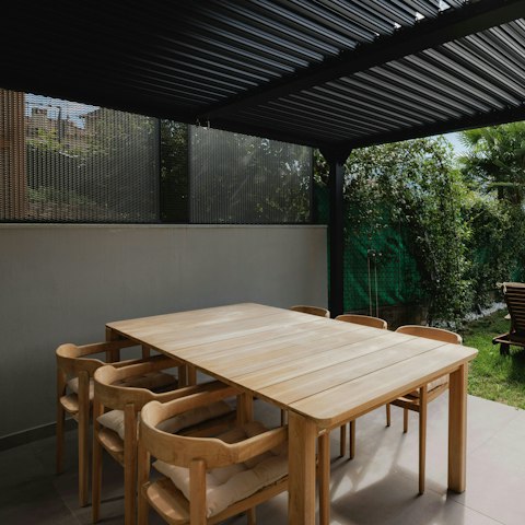 Dine alfresco beneath the shaded pergola