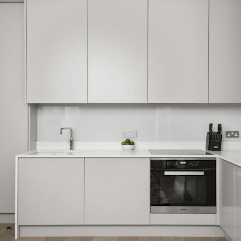 Prepare meals with ease in the sleek white kitchen
