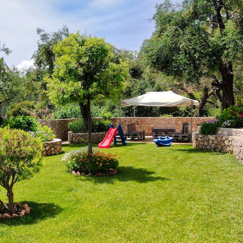 Let the kids play on the lawn, set up with a slide and rocker for little ones