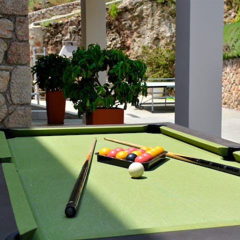 Listen to the soft clack of pool balls as the group has fun in the sun