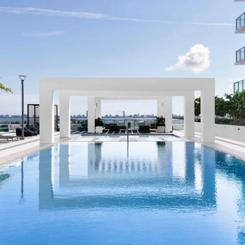 Swim in the shared pool that overlooks Biscayne Bay