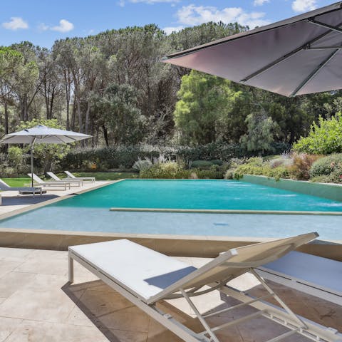 Lounge by the pool with a cocktail and a book