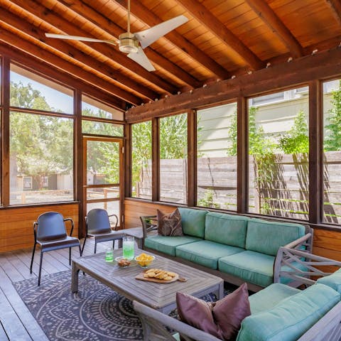 Relax with drinks and games on the screened porch