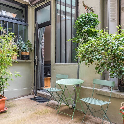 Enjoy your morning cup of coffee in the plant-filled courtyard