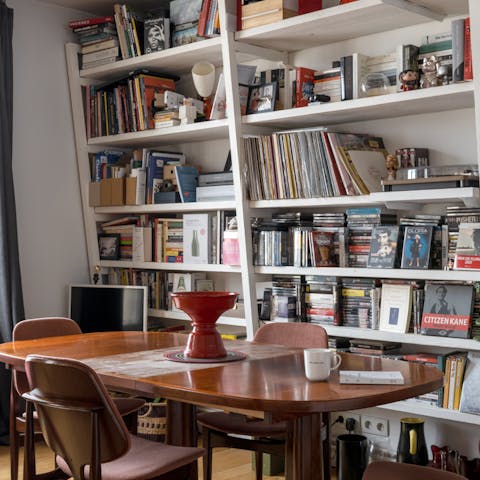Set the dining table for a group breakfast of coffee and croissants