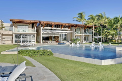 Cool off in the pool as palm trees frame the villa