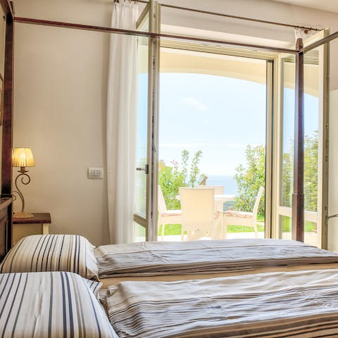 Wake up to sea views from the four-poster bed
