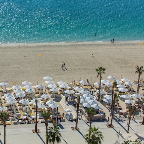 Stretch out and soak up the Dubai sun from your resort's private beach