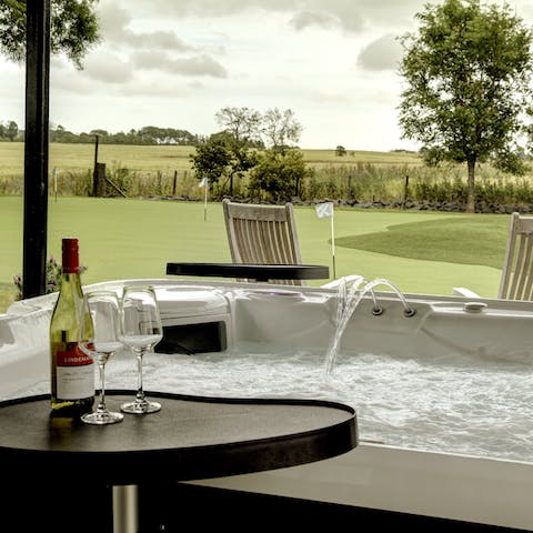 Sip a glass of wine while you soak in the outdoor hot tub