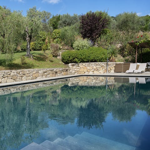 Admire peaceful garden views from the pool