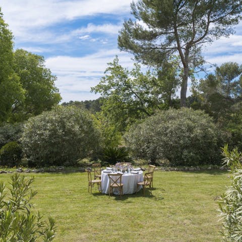 Enjoy dinner on the lawn, surrounded by cypresses