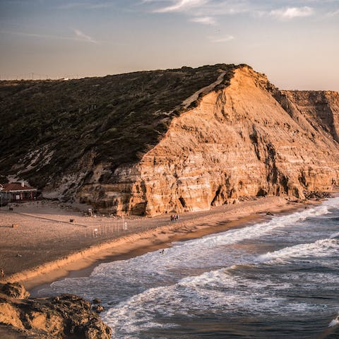 Spend an afternoon on São Julião Beach, a short walk away