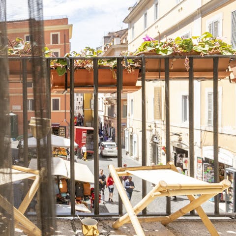 Admire the bustling street views from the private balcony