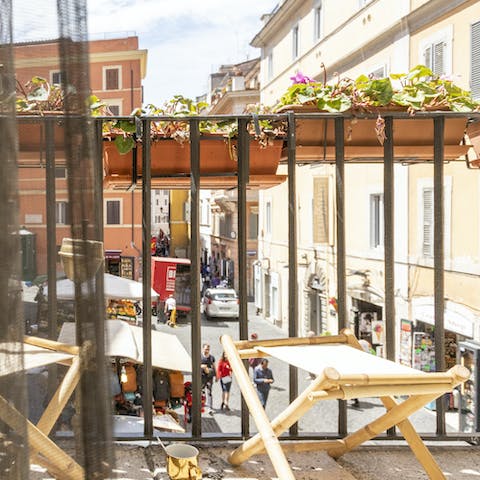Admire the bustling street views from the private balcony