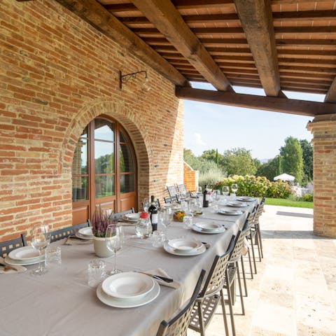 Gather the group and dine at the long table on the covered terrace