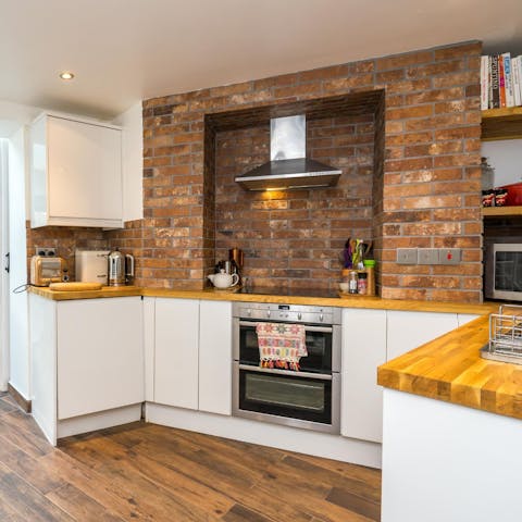 Cook up a feast in the kitchen, complete with exposed brickwork