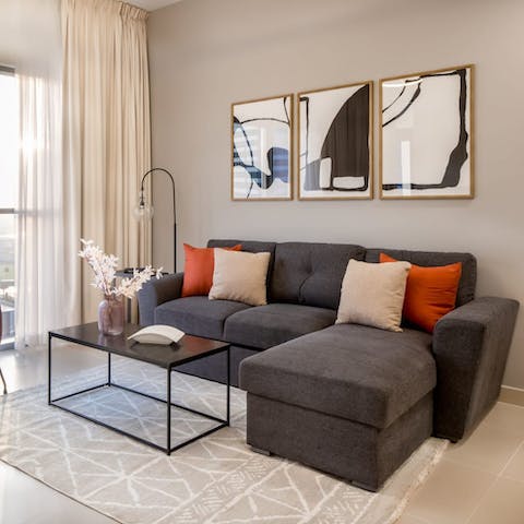 Kick back and relax on the charcoal L-shaped sofa and admire awesome urban views