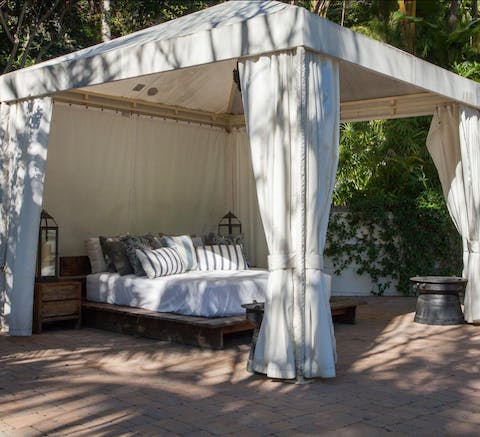 Spendy lazy days reclining on the canopied daybed by the pool