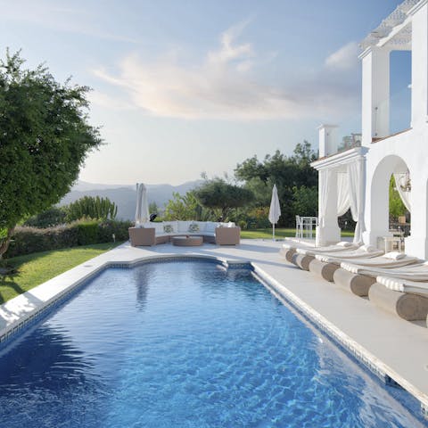 Swim lengths in the pool with a glorious view of the sprawling hillside