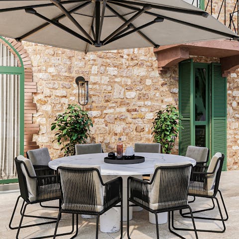 Gather on the patio with a glass of wine from the vineyard