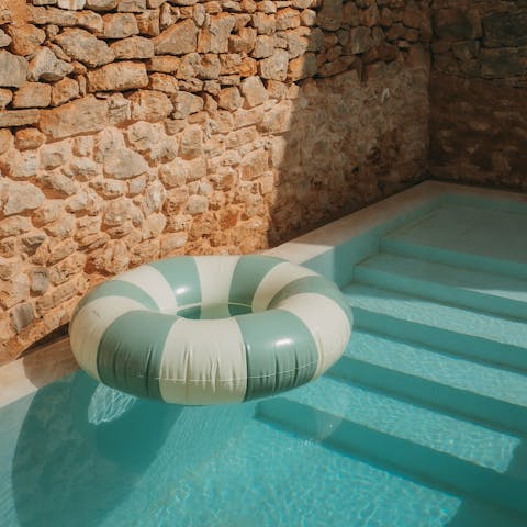 Relax by the pool surrounded by historic stone walls