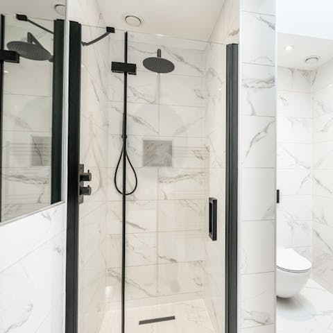 Wash off the day beneath the rainfall shower in the sleek bathroom