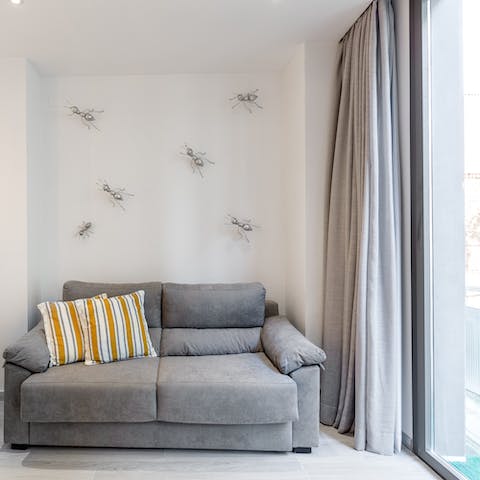 Stretch out on the plump sofa and unwind with a good book