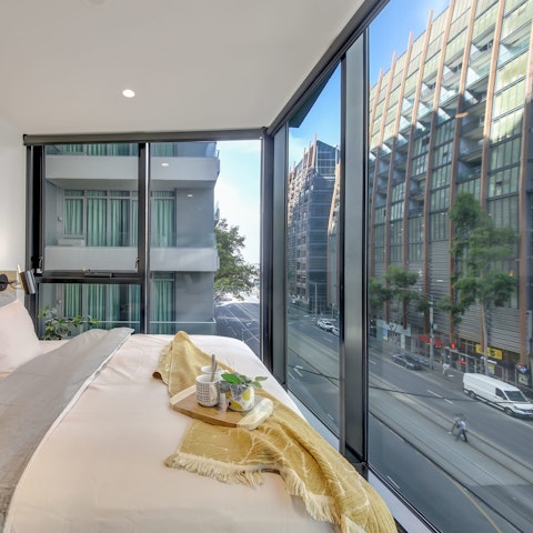 Watch the city come to life below as you sip coffee in bed