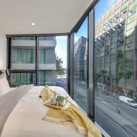 Watch the city come to life below as you sip coffee in bed