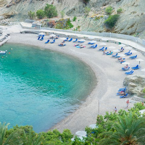 Swim in the crystal clear waters of Istron Bay, less than a ten-minute walk from your home