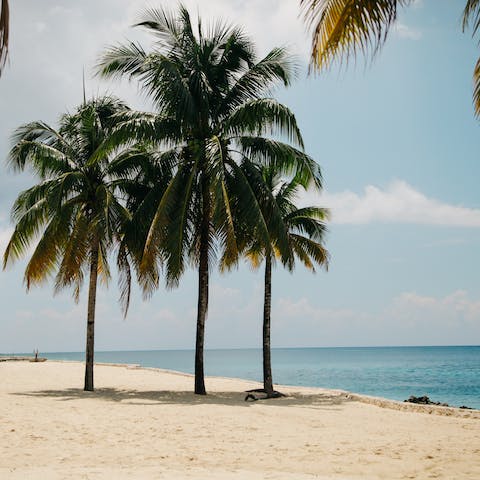 Sink your toes into the white powdered sands of the private beach, it's just steps away