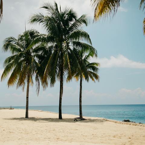 Sink your toes into the white powdered sands of the private beach, it's just steps away