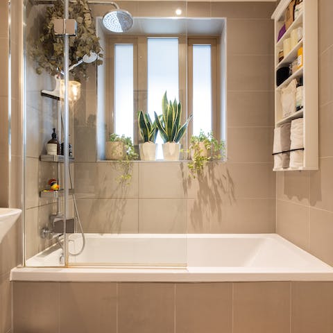 Relax and unwind beneath the bathroom's rainfall shower