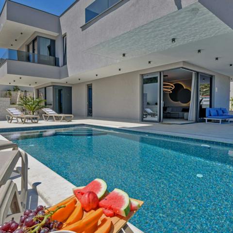 Slip into the pristine swimming pool to cool off on a sunny day